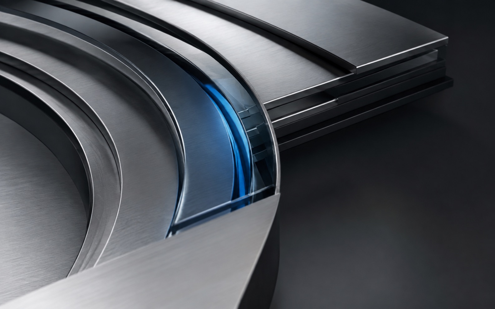 Abstract precision-engineered metal layers with a blue glass detail